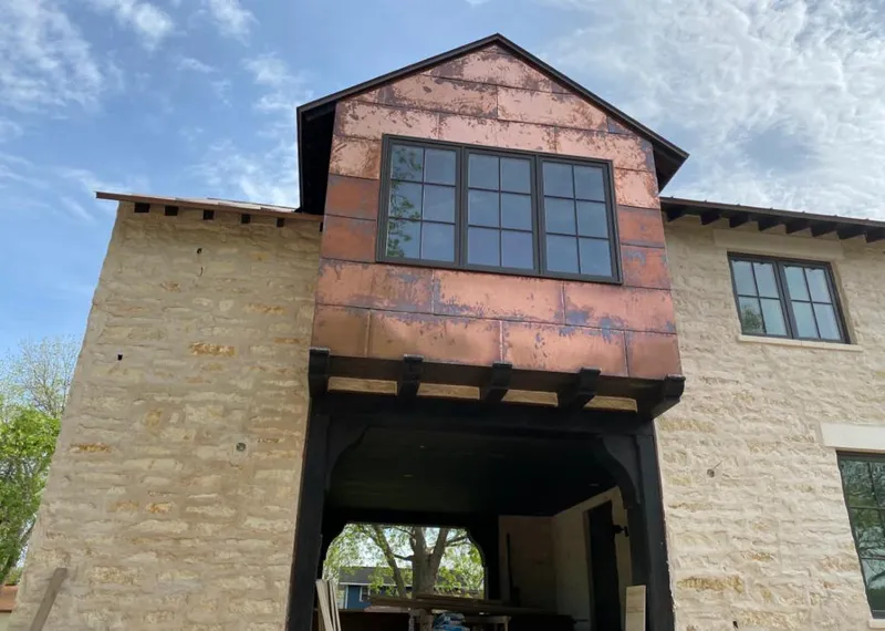 Copper metal panel facade on a stone building for Skylight Installation in Reedley